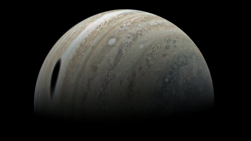 Jupiter's big moon Ganymede casts giant shadow in stunning Juno photo by citizen scientist