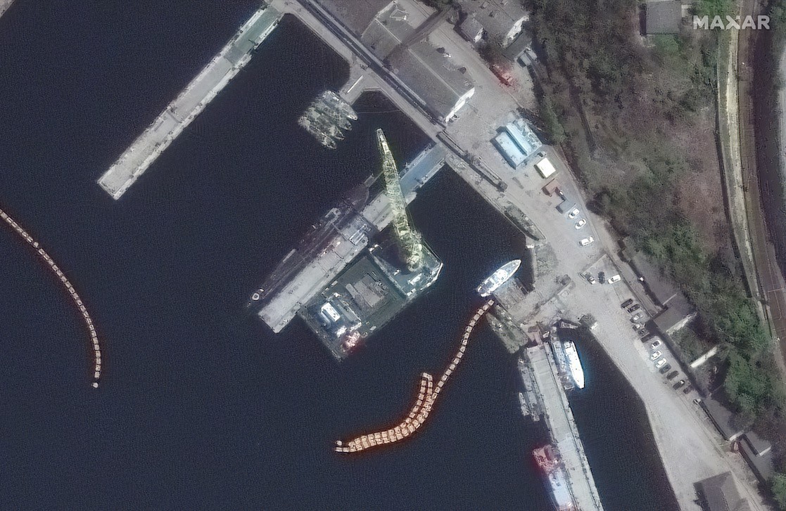 Satellite photos show missiles being loaded onto Russian submarine. Dolphin pens, too.