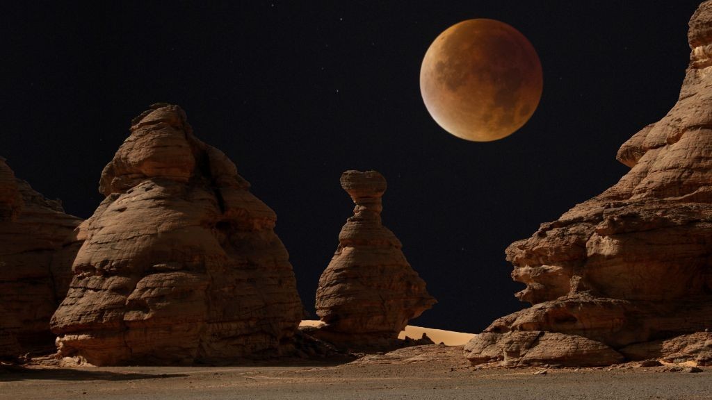 Why does the moon turn red during a total lunar eclipse?