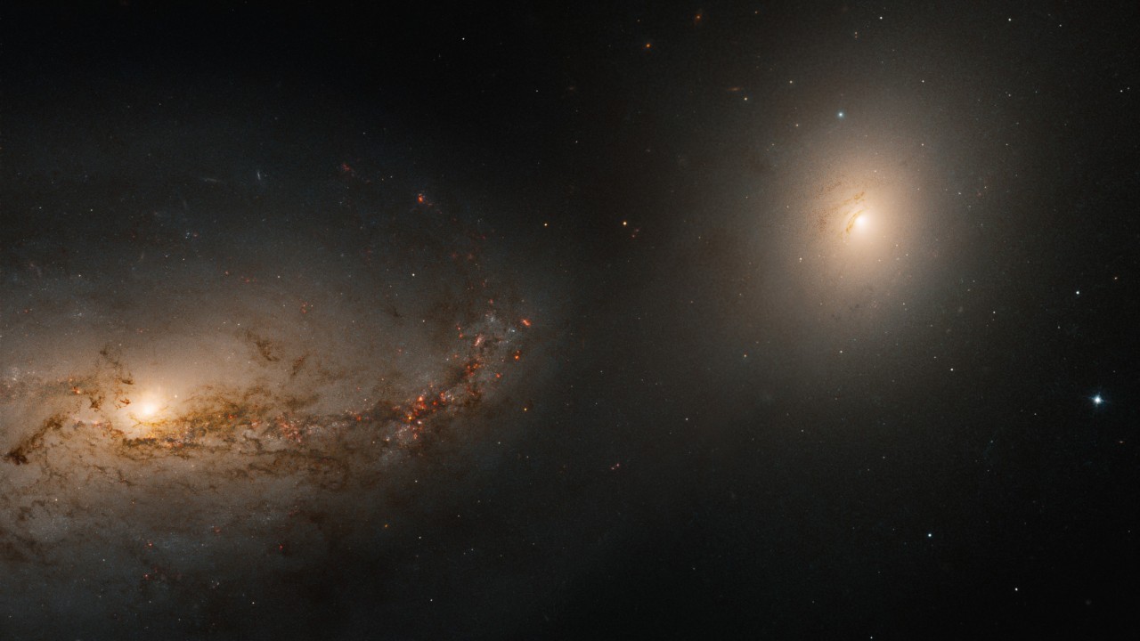 Hubble telescope sees haunting galactic dance of 2 galaxies linked by the corpse of a cannibalized neighbor