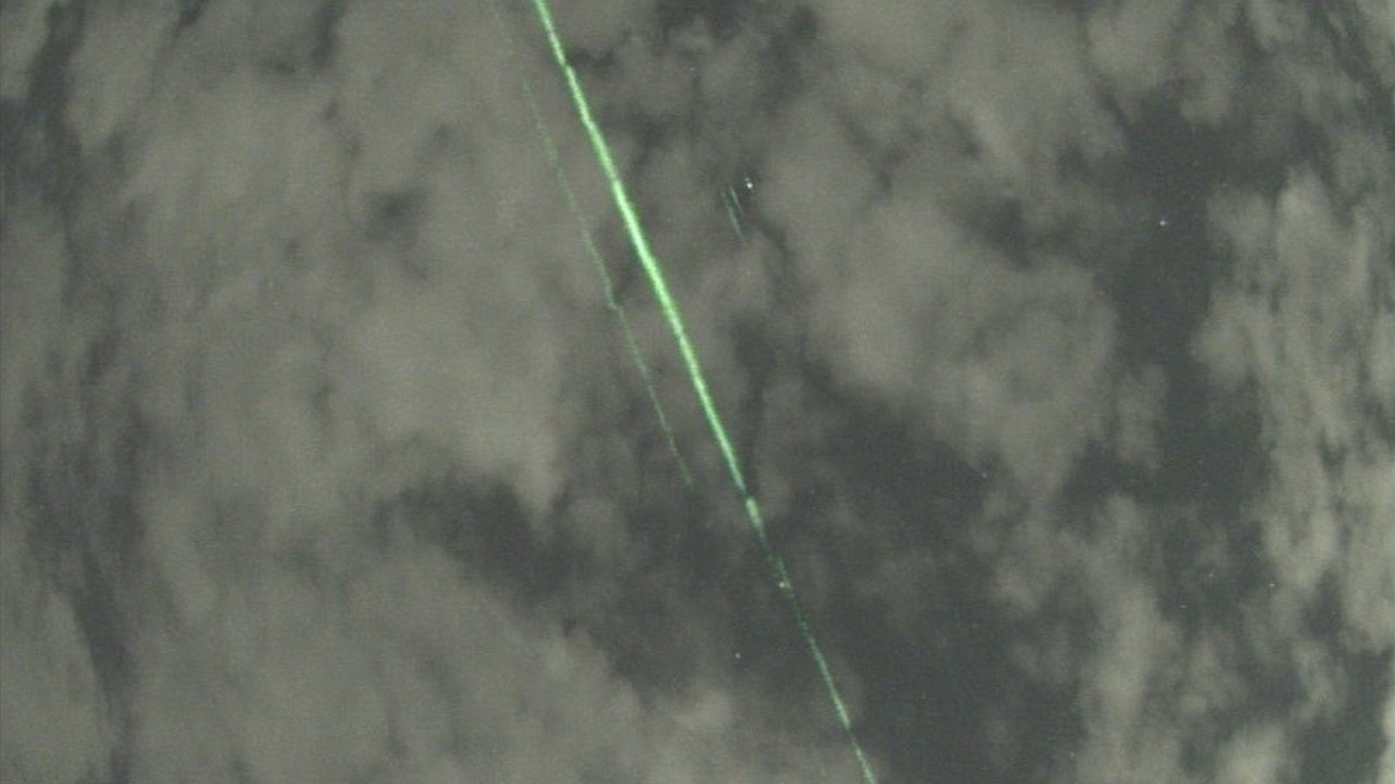 Mysterious green lasers caught on camera belong to NASA satellite (video)