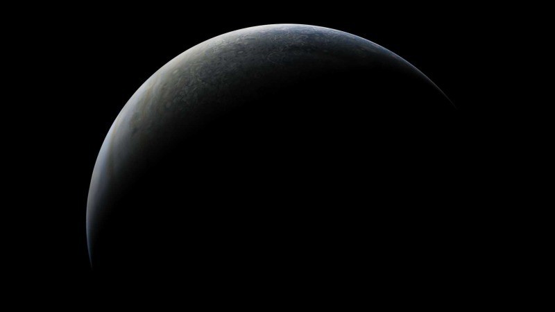 NASA probe snaps stunning photos of crescent Jupiter and its moon Ganymede